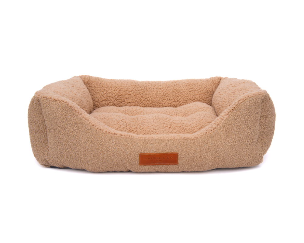 The luxury boucle and teddy-bear fabric nest bed against a white background